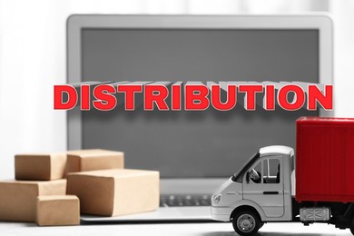 Image of Distribution. Toy truck, mini boxes and laptop