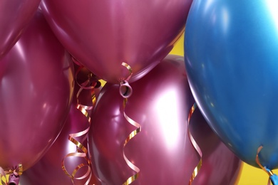 Photo of Bunch of bright balloons, closeup view. Party objects