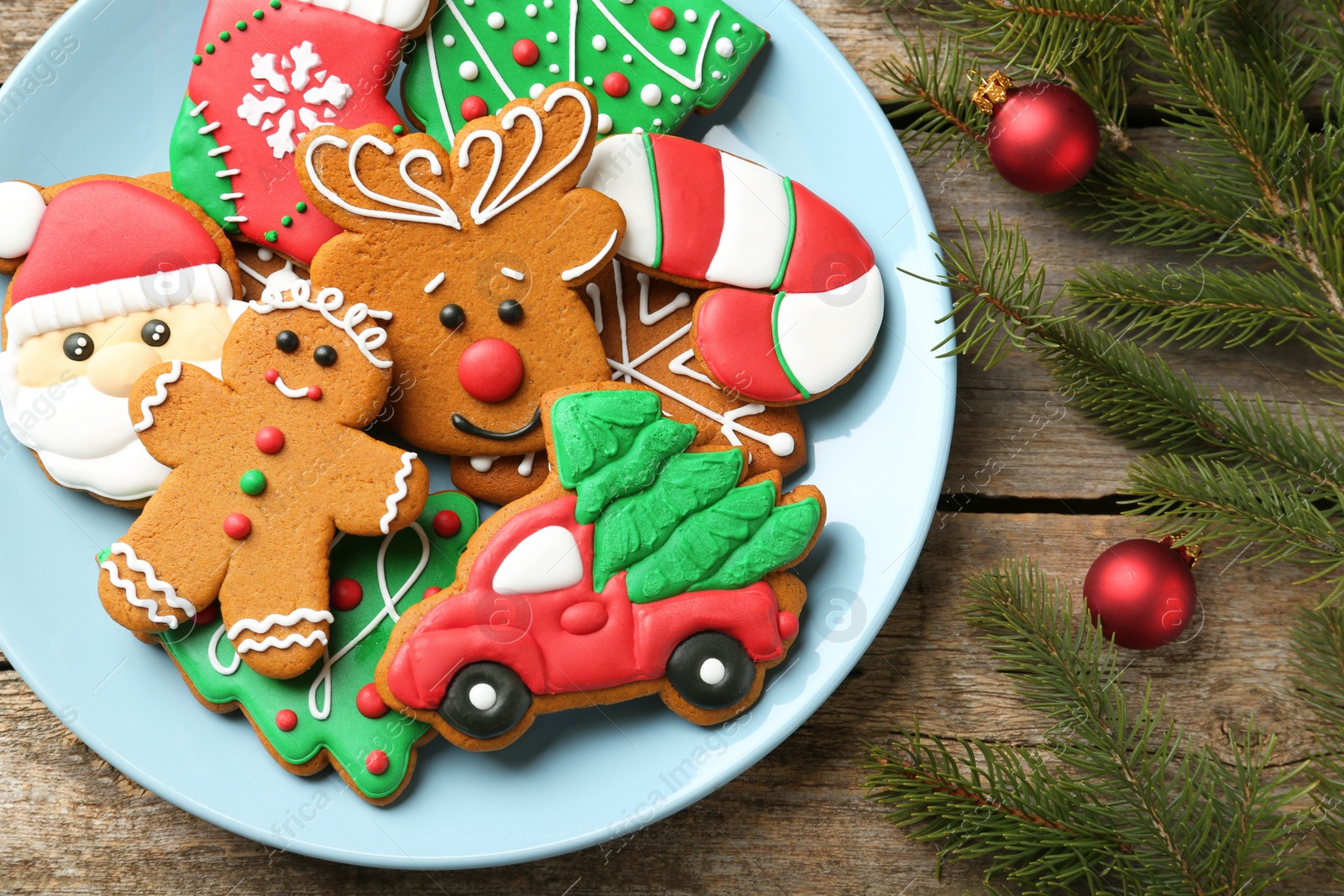 Photo of Different tasty Christmas cookies and decor on wooden table, flat lay