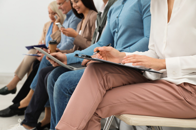 People waiting for job interview in office, closeup