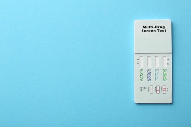 Photo of Multi-drug screen test on light blue background, top view. Space for text