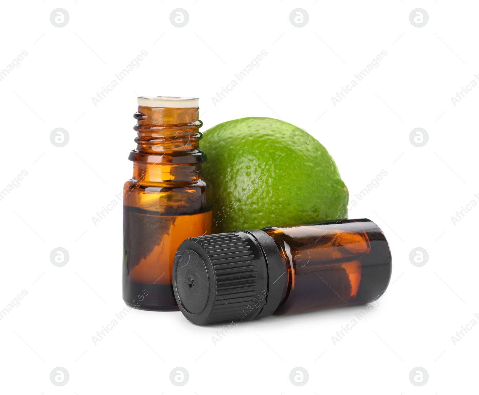 Photo of Bottles of citrus essential oil and fresh lime isolated on white