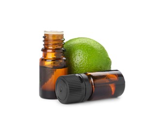 Photo of Bottles of citrus essential oil and fresh lime isolated on white