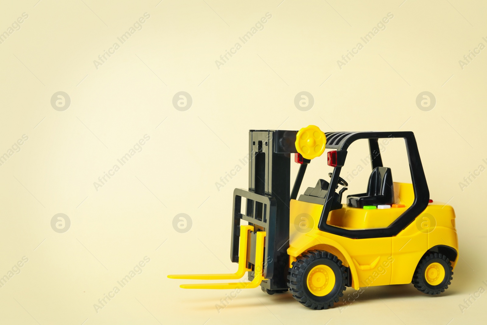 Photo of Toy forklift on beige background, space for text. Logistics and wholesale concept