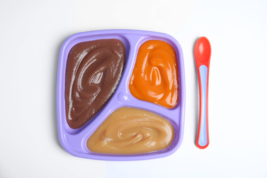 Photo of Healthy baby food and spoon on white background, flat lay