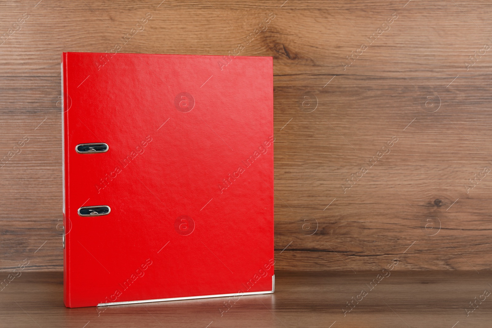 Photo of Red office folder on wooden table, space for text
