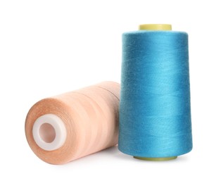 Photo of Different colorful sewing threads on white background