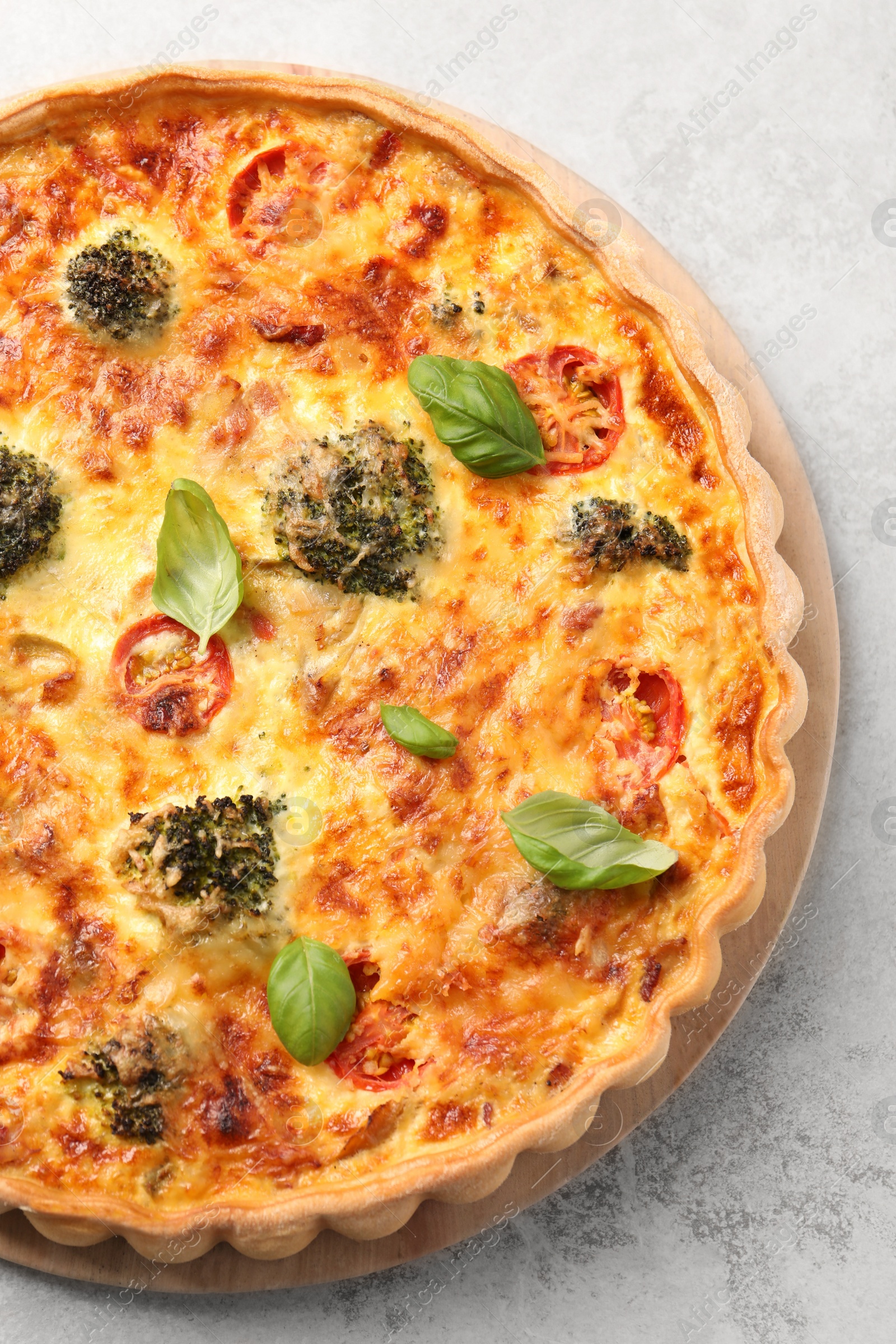 Photo of Delicious homemade vegetable quiche on light gray table, top view