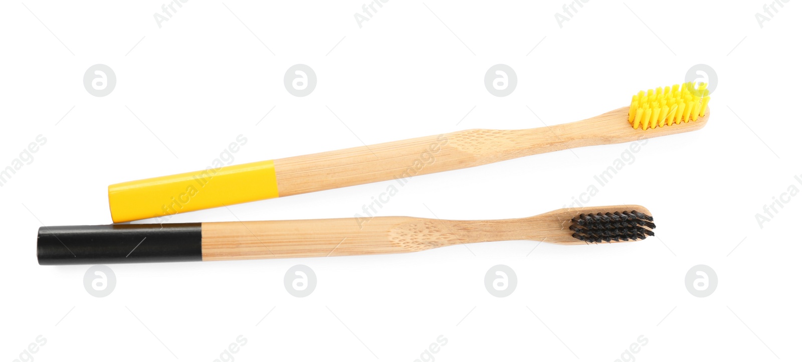 Photo of Natural toothbrushes made with bamboo isolated on white, top view