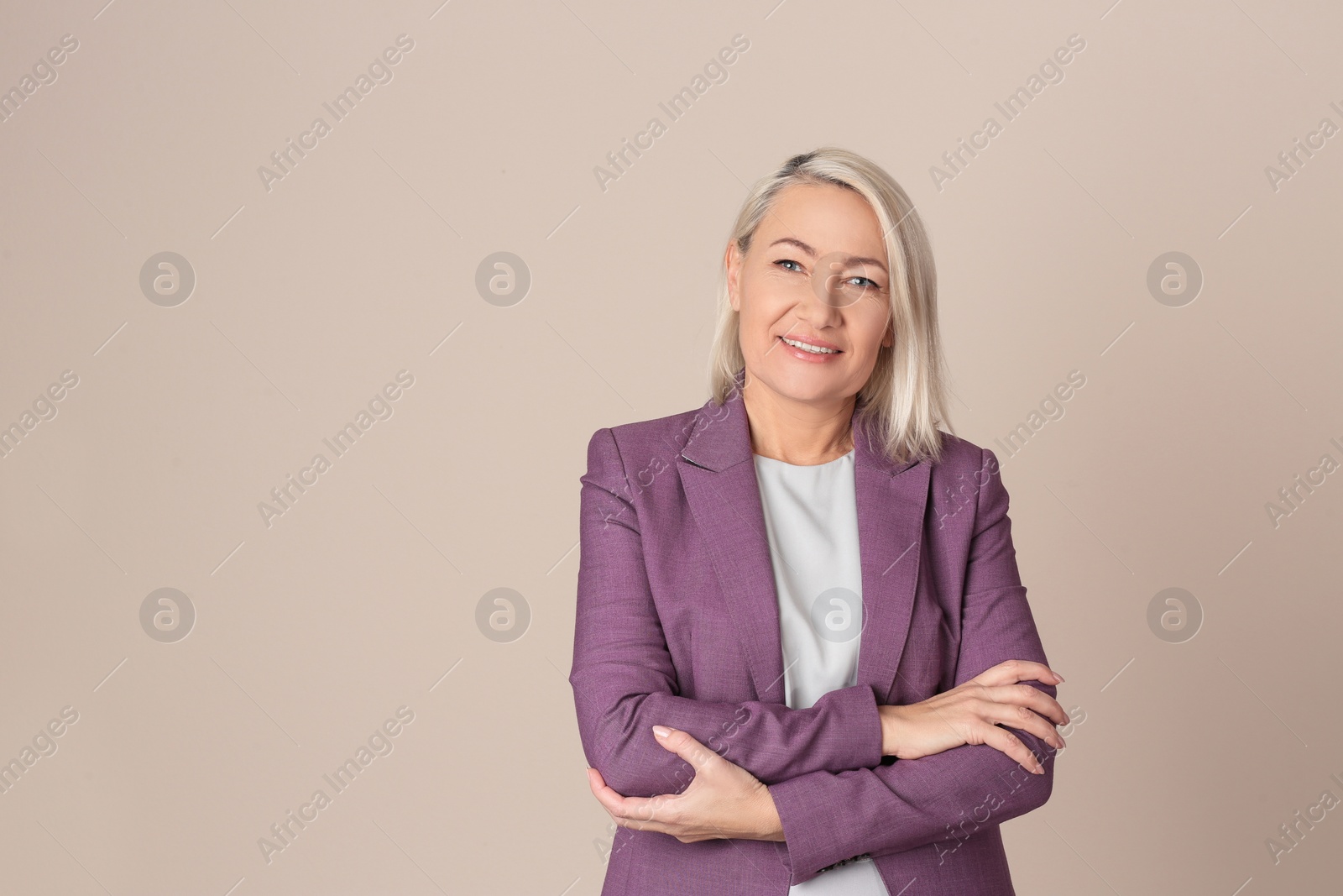 Photo of Portrait of beautiful mature woman on beige background. Space for text