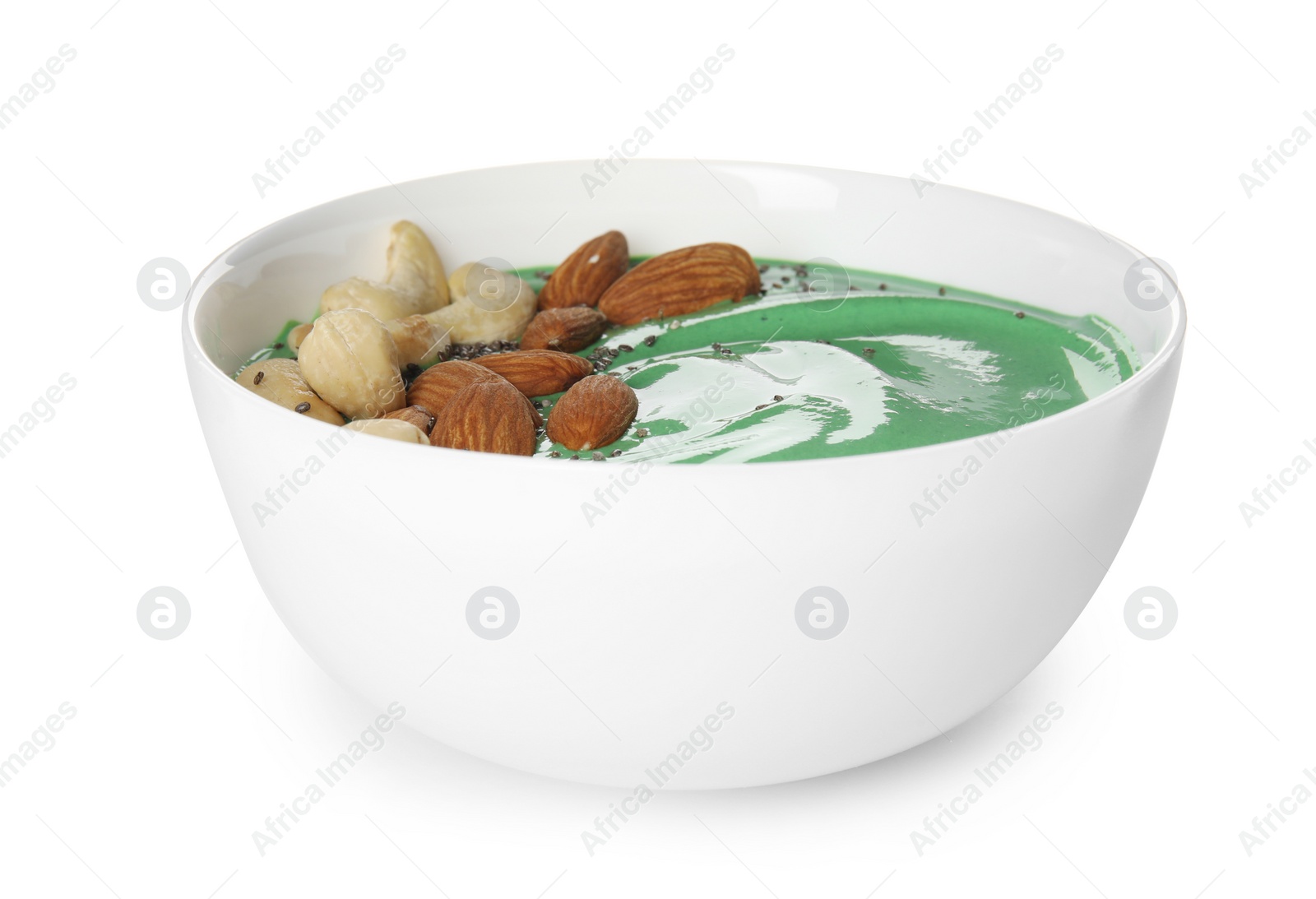 Photo of Bowl of spirulina smoothie with nuts isolated on white