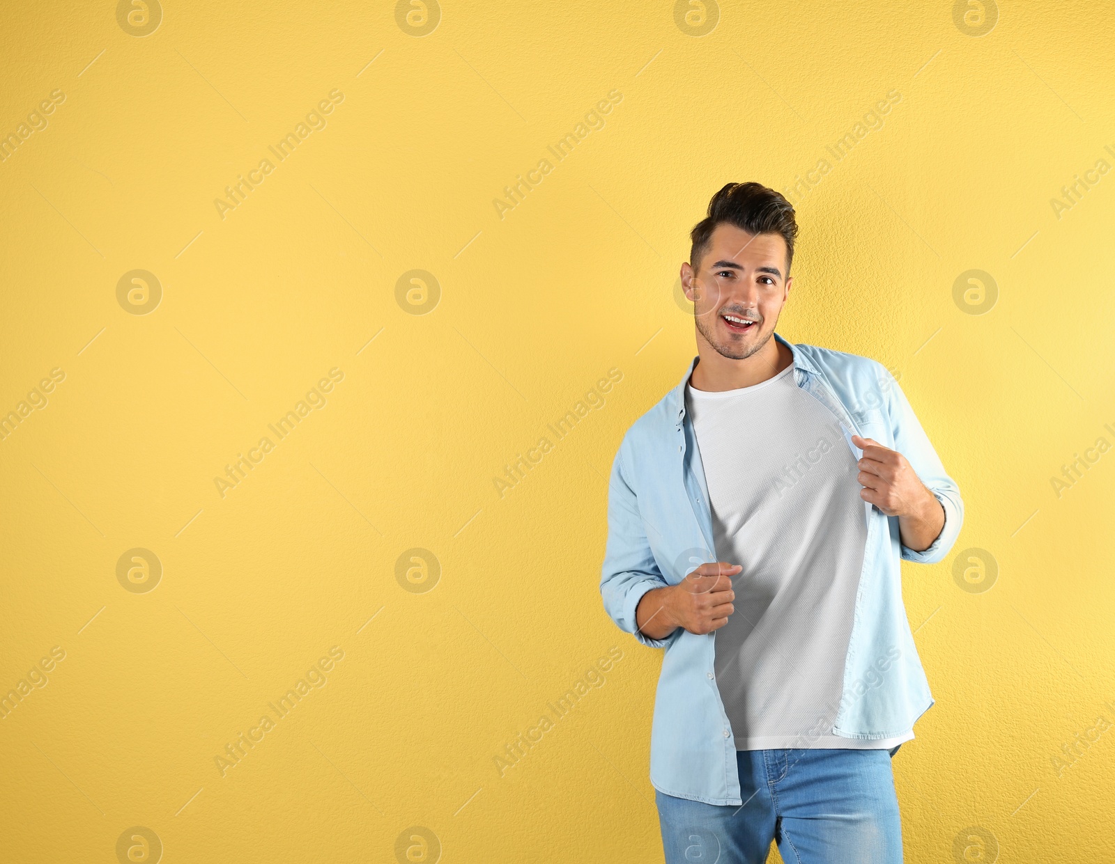 Photo of Young man in t-shirt on color background. Mockup for design