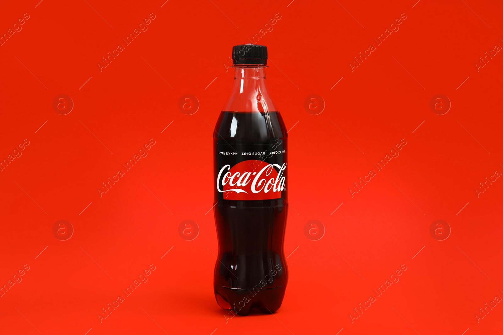 Photo of MYKOLAIV, UKRAINE - NOVEMBER 14, 2018: Bottle of Coca-Cola on color background