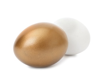 Golden egg and ordinary one on white background