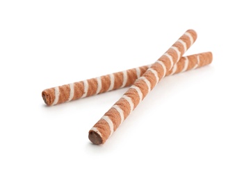 Delicious chocolate wafer rolls on white background. Sweet food