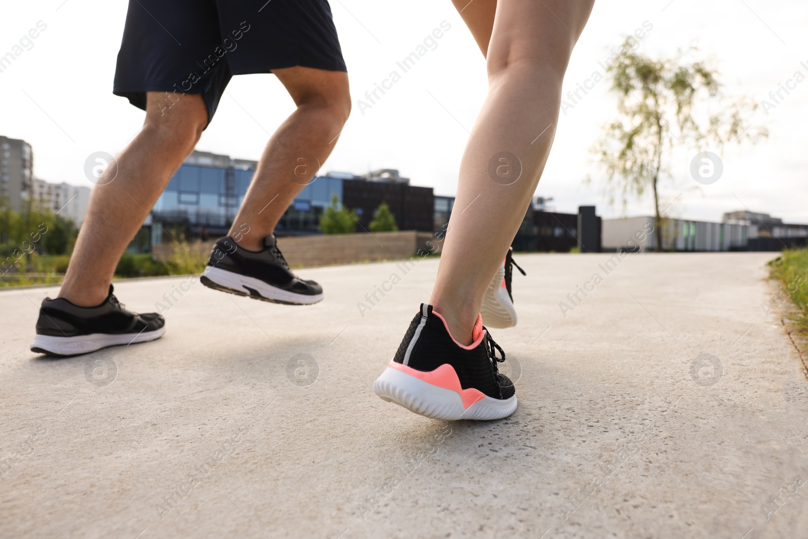 Photo of Healthy lifestyle. Couple running outdoors, low angle view