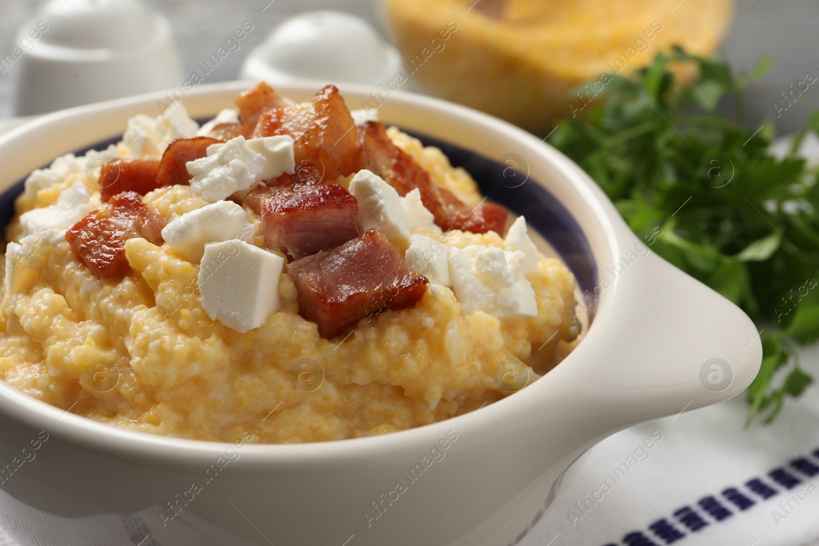 Photo of Delicious traditional Ukrainian banosh in bowl on table, closeup