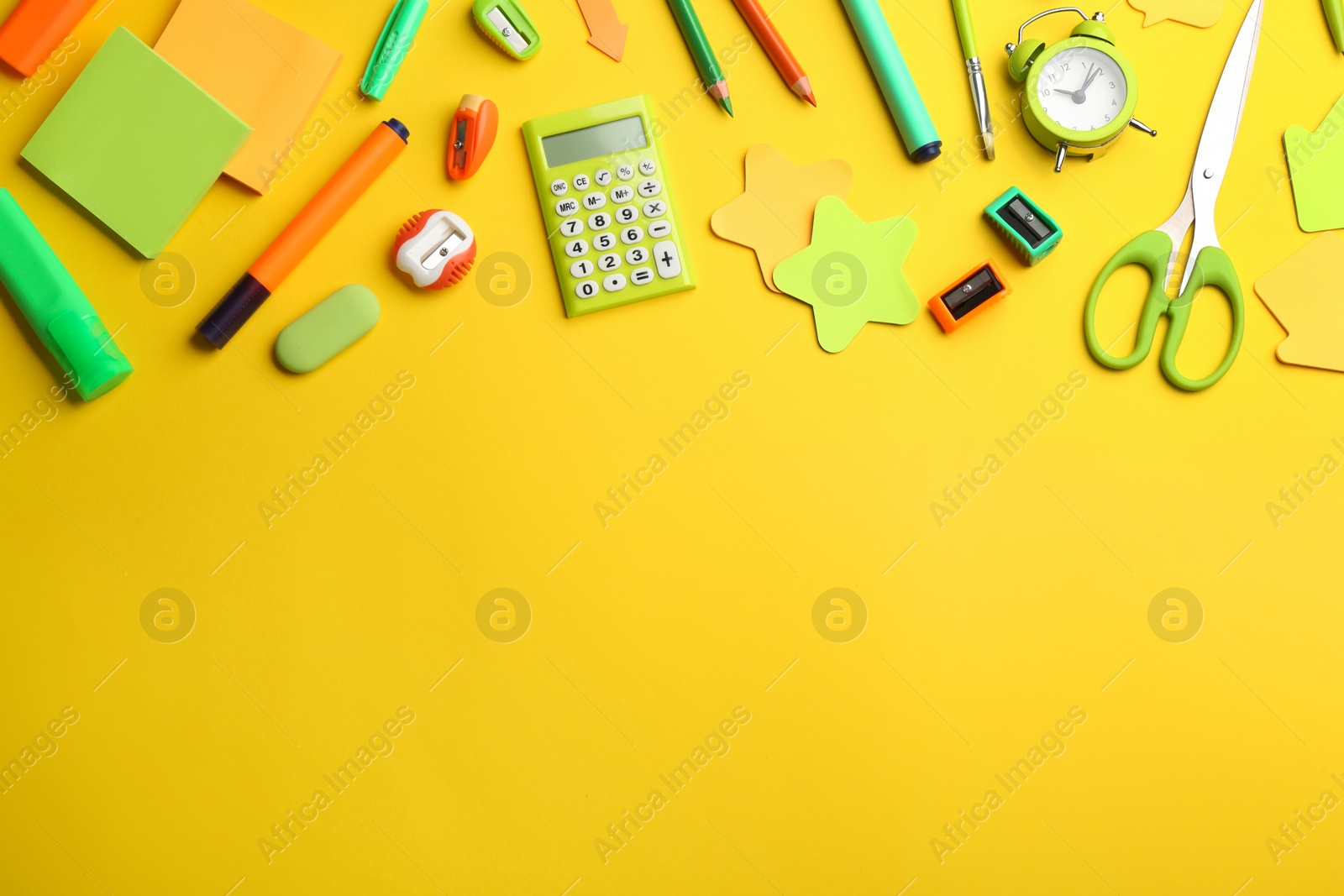 Photo of School stationery on yellow background, flat lay with space for text. Back to school