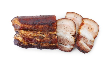 Photo of Pieces of tasty baked pork belly isolated on white, top view