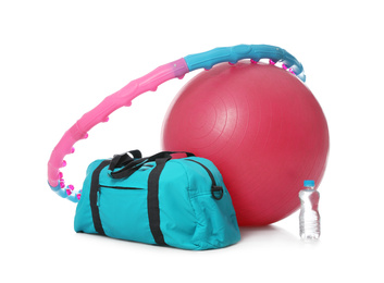 Photo of Fitness ball, gym bag, bottle of water and hula hoop isolated on white