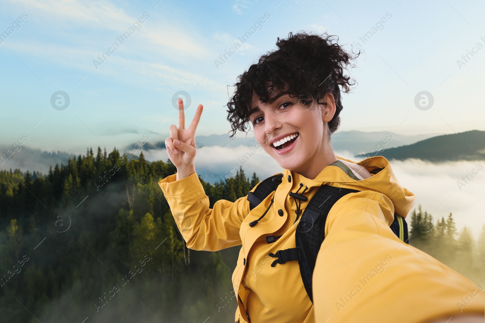 Image of Beautiful young woman taking selfie in mountains