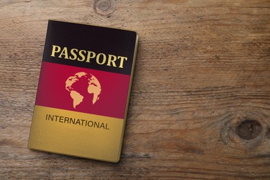 Image of Passport in case with imageGerman flag on wooden table, top view. Space for text