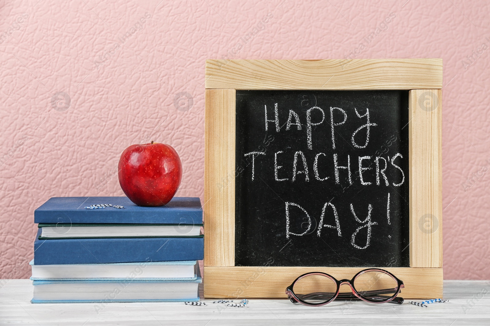 Photo of Composition with small chalkboard for Teacher's day on table