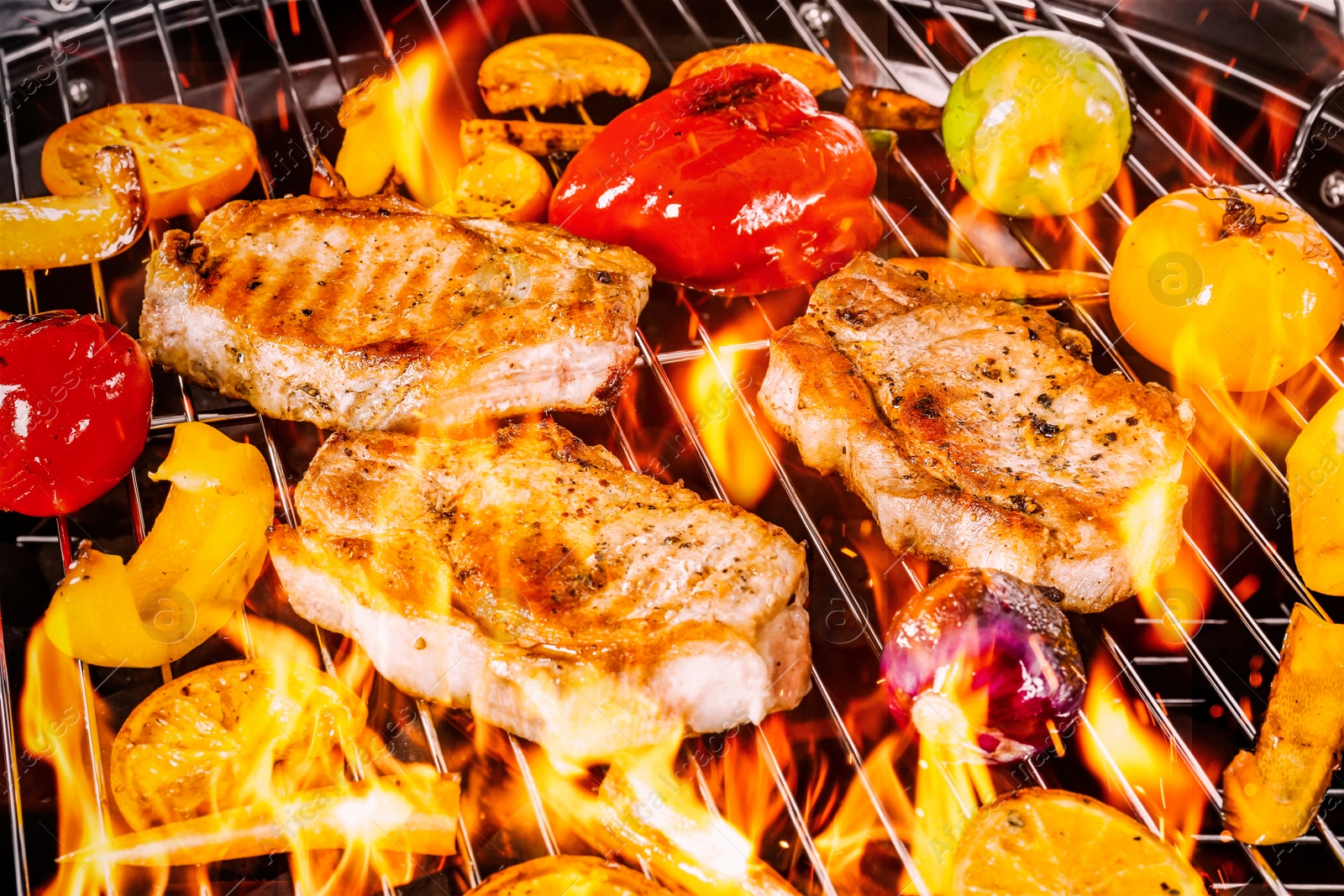 Image of Barbecue grill with food and flame, closeup