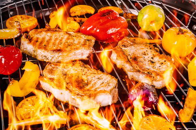 Image of Barbecue grill with food and flame, closeup