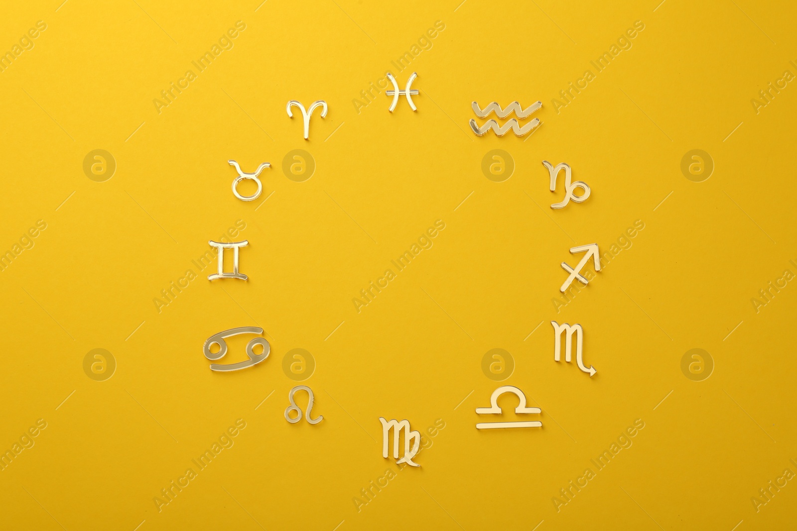 Photo of Zodiac signs on yellow background, flat lay. Space for text