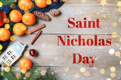 Image of Saint Nicholas Day. Flat lay composition with tangerines on wooden background