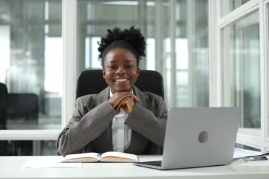 Happy woman working at table in office. Lawyer, businesswoman, accountant or manager