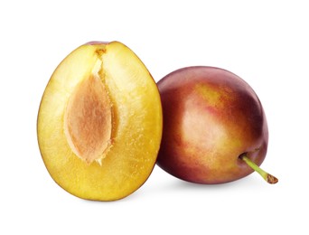 Whole and cut ripe plums on white background