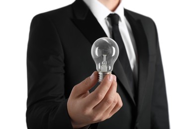 Man holding incandescent light bulb on white background, closeup