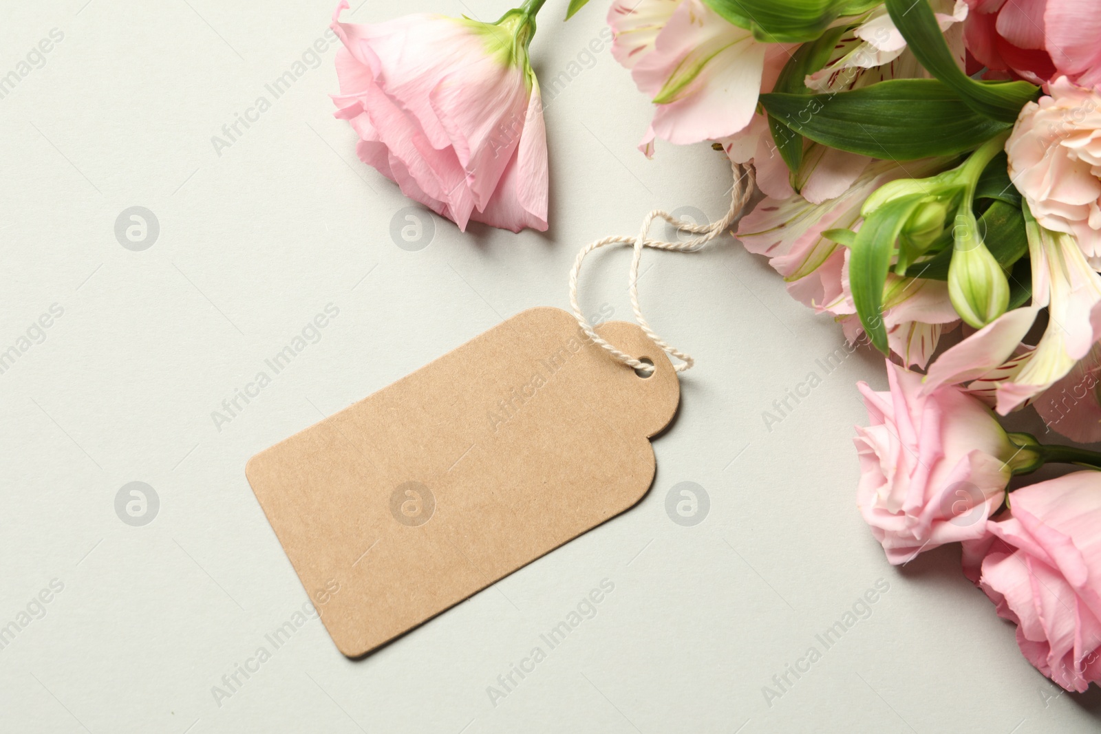 Photo of Happy Mother's Day. Beautiful flowers with blank card on light background, flat lay