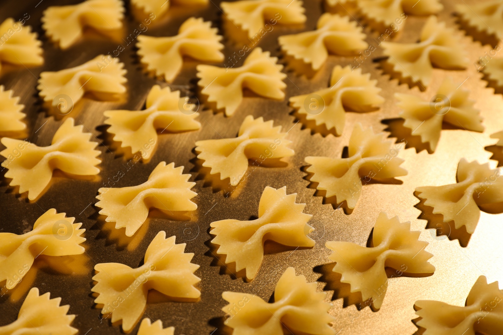 Photo of Uncooked organic farfalline pasta on table, closeup
