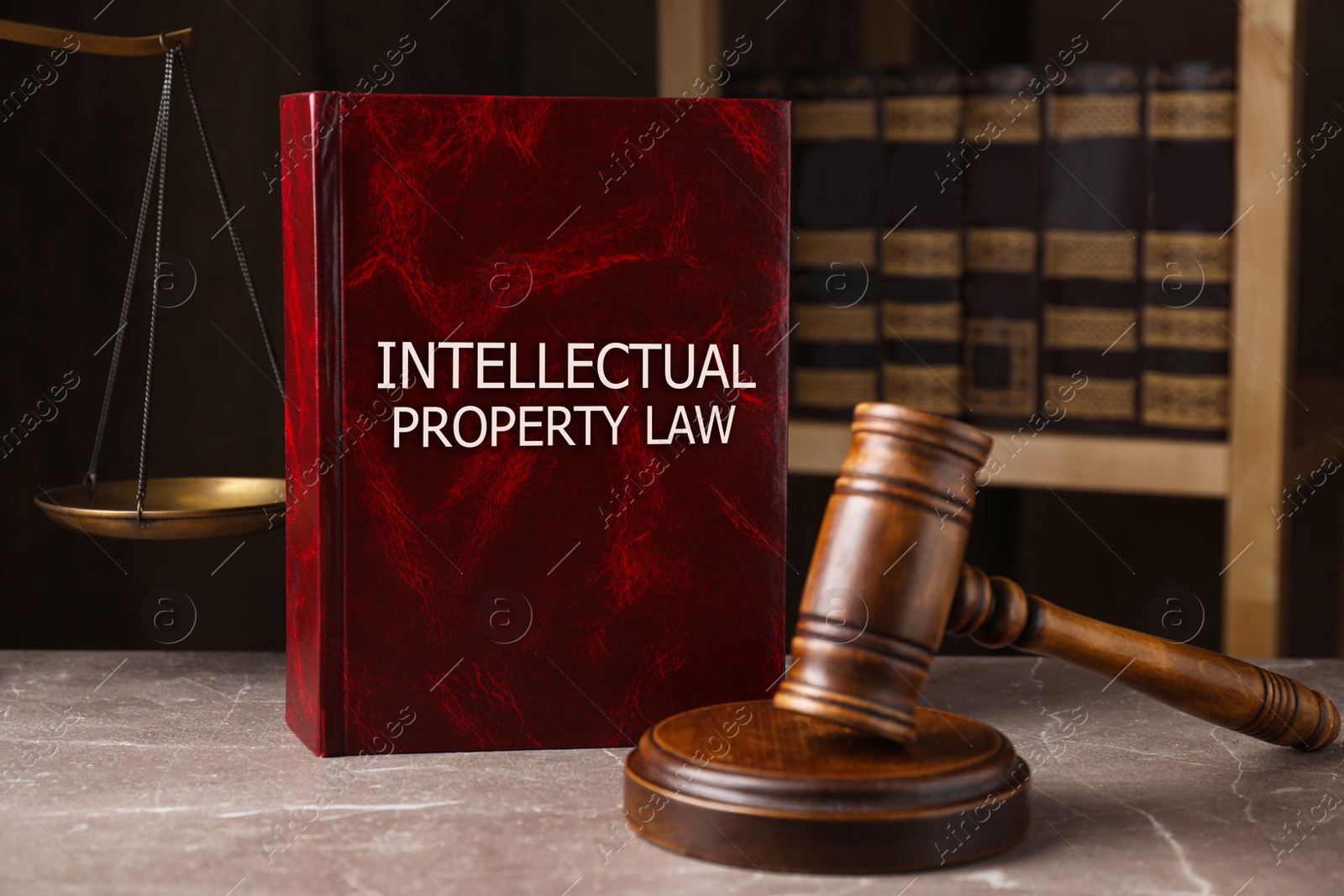 Image of Intellectual Property law book and judge's gavel on grey marble table