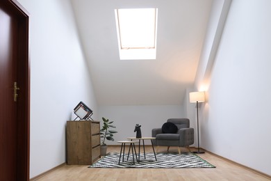 Photo of Attic room interior with slanted ceiling and furniture