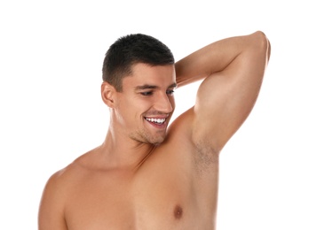 Handsome man showing hairy armpit on white background. Epilation procedure