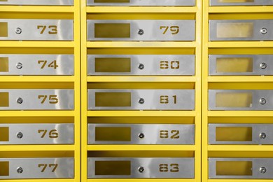 Photo of Many closed metal mailboxes with keyholes and numbers as background