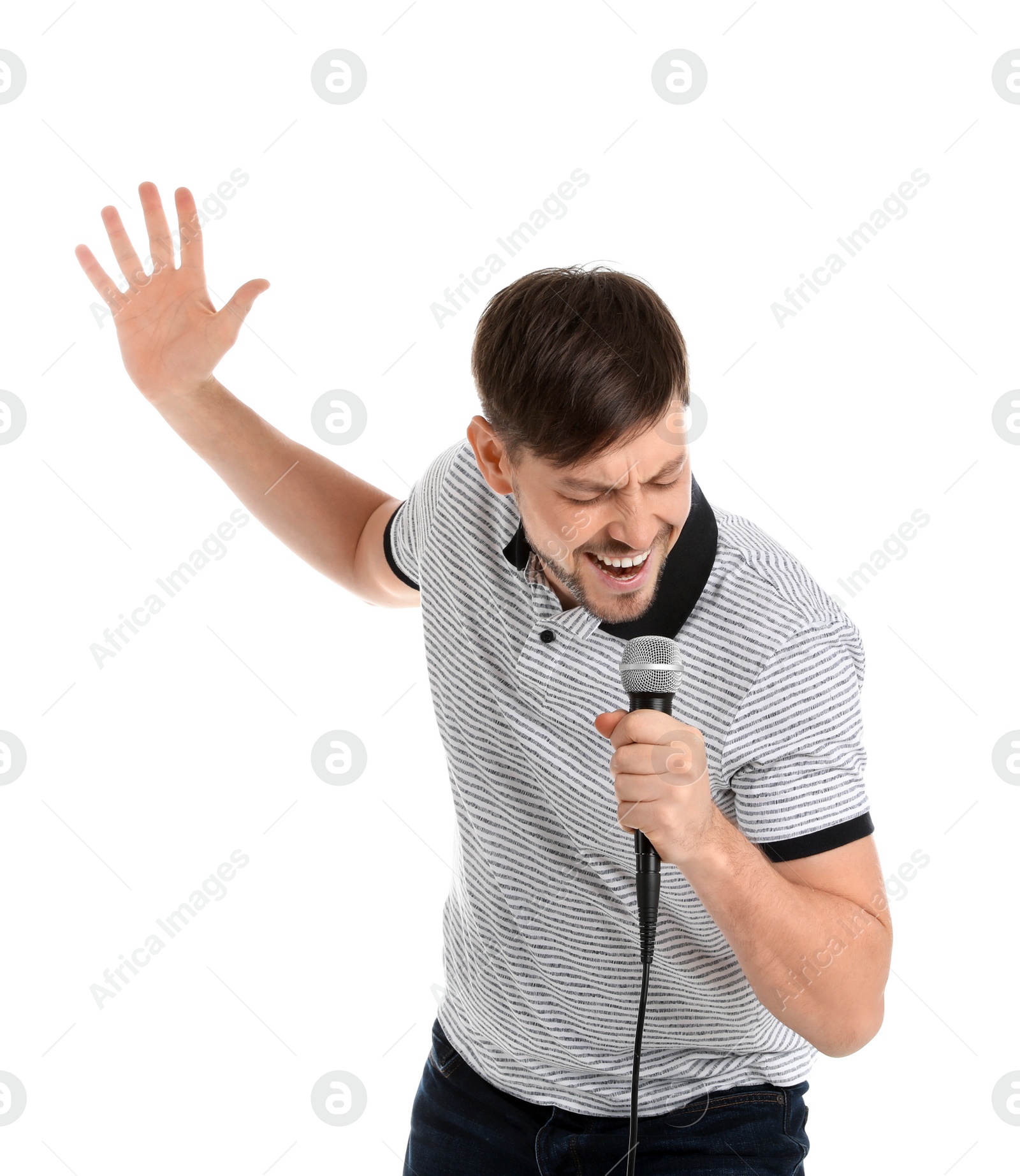 Photo of Handsome man in casual clothes singing with microphone on white background