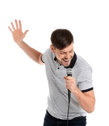 Handsome man in casual clothes singing with microphone on white background