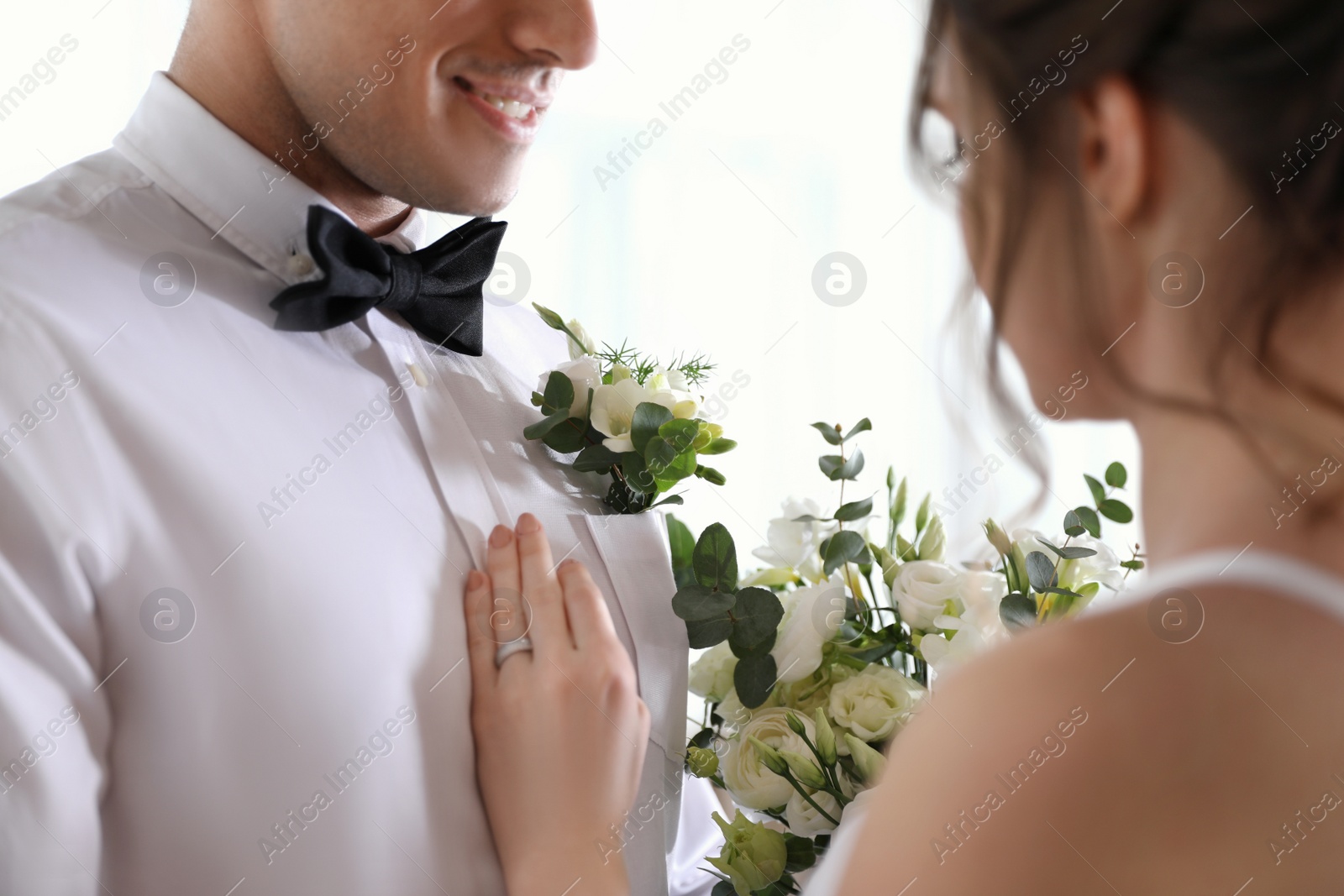 Photo of Happy newlywed couple dancing together indoors, closeup