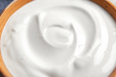 Photo of Bowl with yummy yogurt, closeup