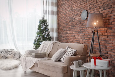 Photo of Decorated Christmas tree in stylish living room interior