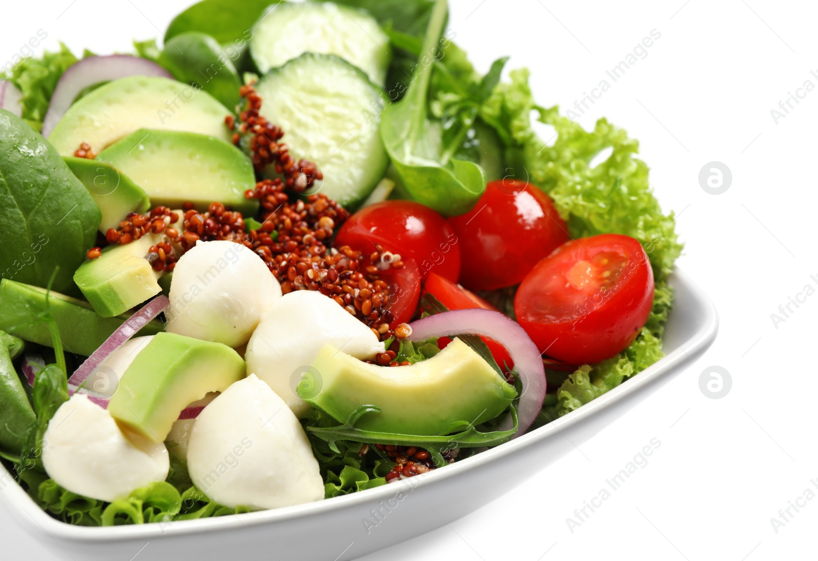 Image of Delicious salad with avocado and quinoa in bowl on white background, closeup