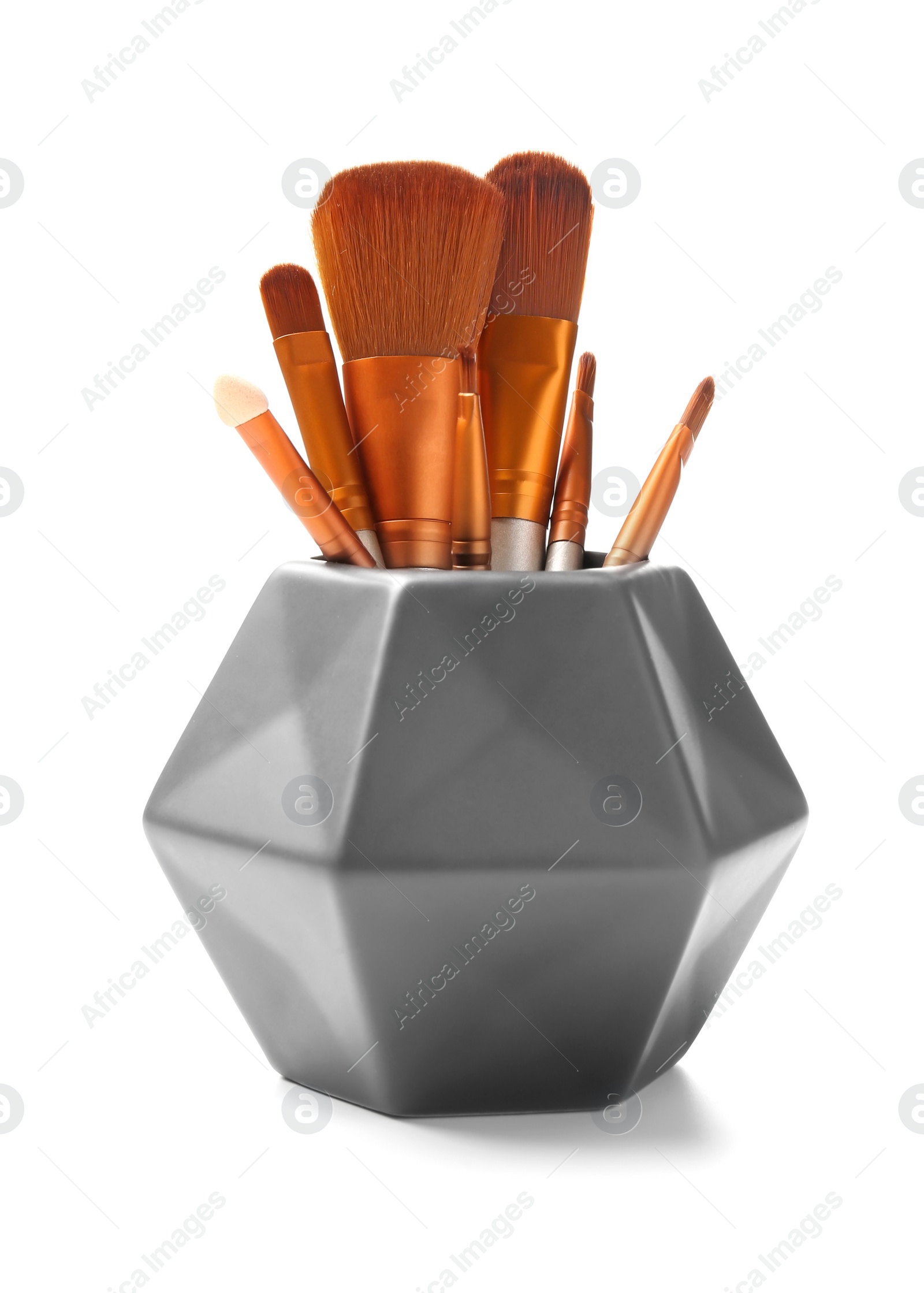 Photo of Holder with makeup brushes of professional artist on white background