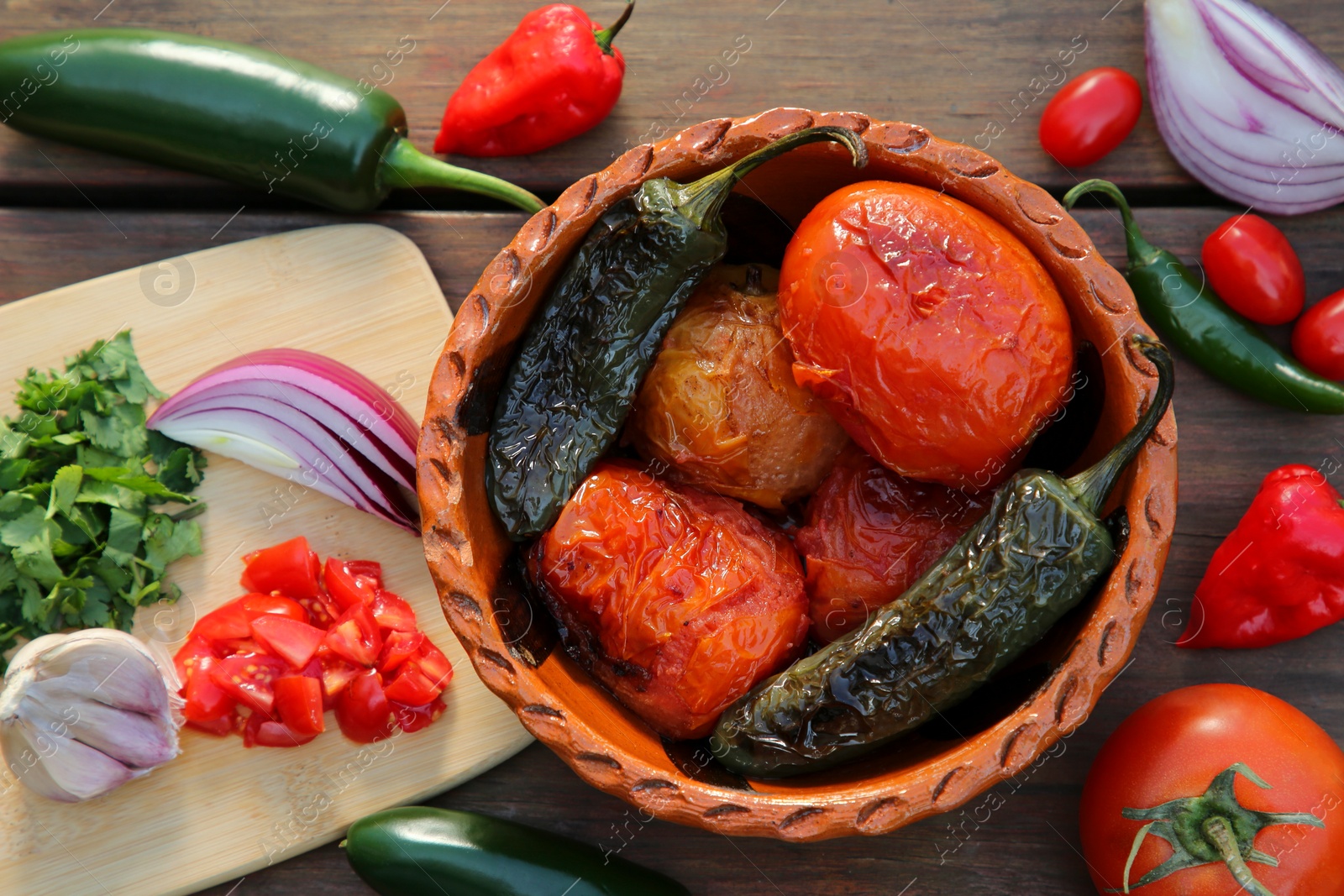 Photo of Ingredients for tasty salsa sauce on wooden table, flat lay