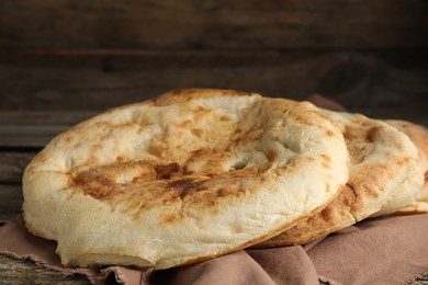 Delicious fresh pita bread on wooden table