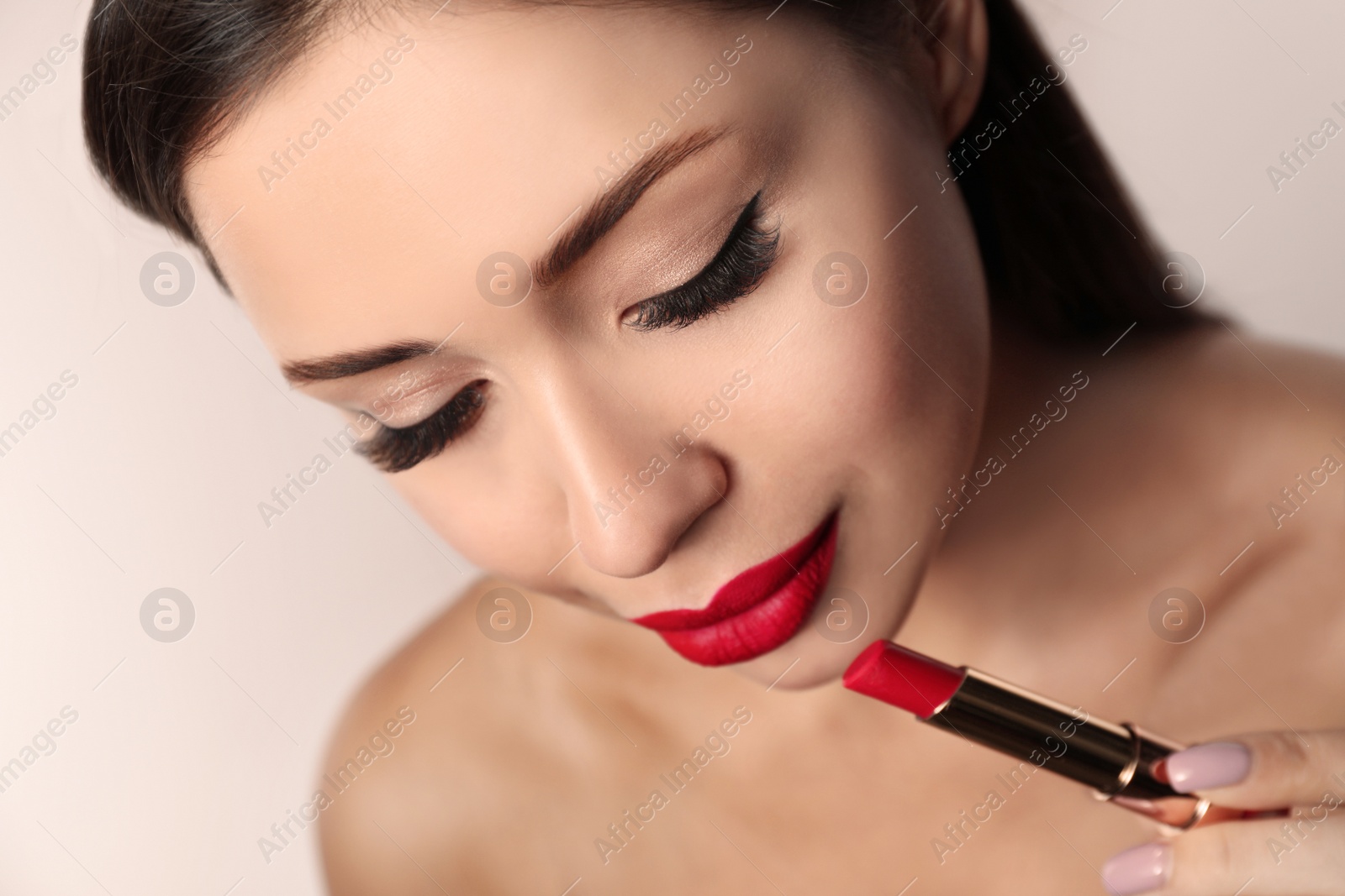 Photo of Beautiful woman with red lipstick on light background